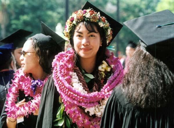 A happy woman graduate decked out in flowers