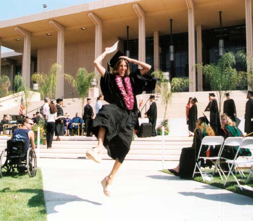 Woman graduate leaping for joy