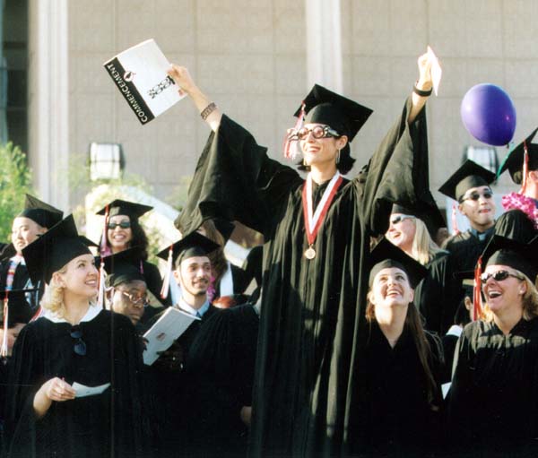 Woman graduate leading peers in celebration