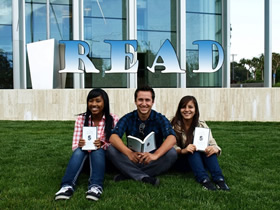 Abrielle, Moises, and Alexa reading "The Glass Castle" outside the Valley Performing Arts Center