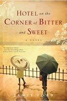 Two children walk by an iron railing above the sea; the girl has a Japanese umbrella; the boy, a plain black American umbrella and a lunchbox.