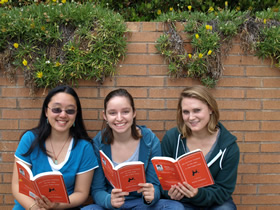 Three students reading "The Curious Incident of the Dog in the Night-time"