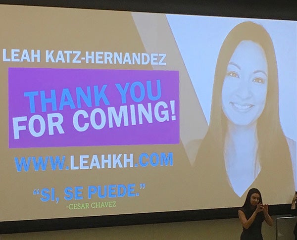 Leah Katz Hernandez in front of her presentation