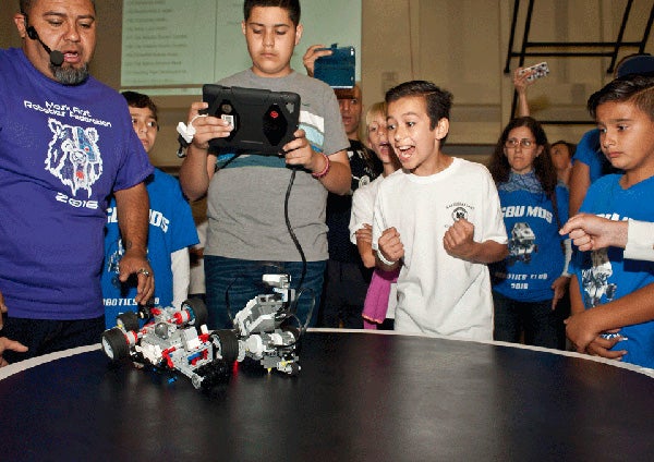 Students controlling fighting robots