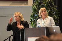 Rebecca Mieliwocki speaking alongside an ASL interpreter