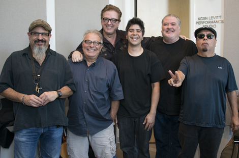 Photo of Los Lobos band members with General Manager Sky Daniels inside the KCSN radio station