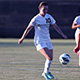 Women’s soccer player dribbles the ball.