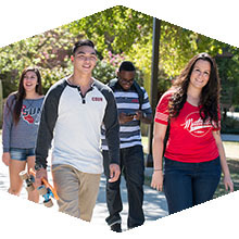 A group of students stride purposefully on the CSUN campus. 