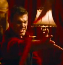 Screengrab of student film Misdirection showing a man throwing a deck of cards at the viewer.