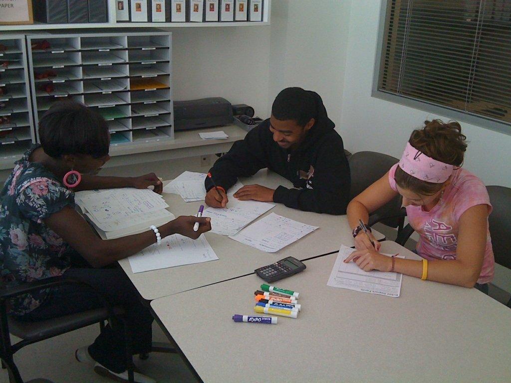 Three student-athletes studying.
