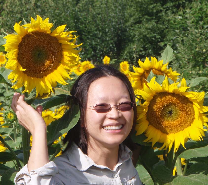 A picture of Dr. Gina Masequesmay with sunflowers in Dieulivol, France