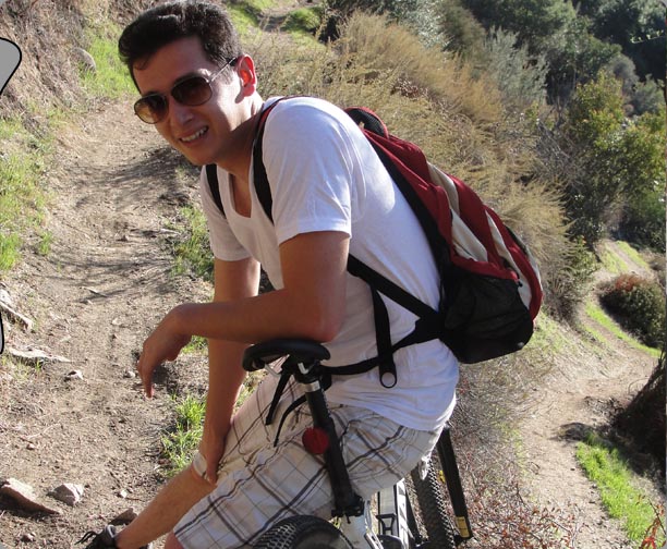 Jose resting on the side of the mountain sitting on his Giant bike