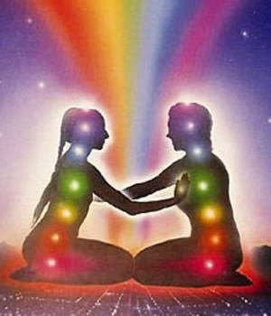 rainbow couple sitting in lotus position joining palms