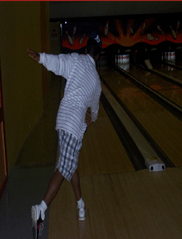 This is a picture of me at the bowling alley wearing my blue and white polo with blue plaid shorts. In the picture im bowling and ended up with perfect form, no wonder I got strike.