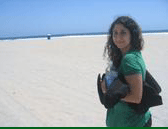 My girlfriend in San Diego looking at the camera with endless sand in the background.