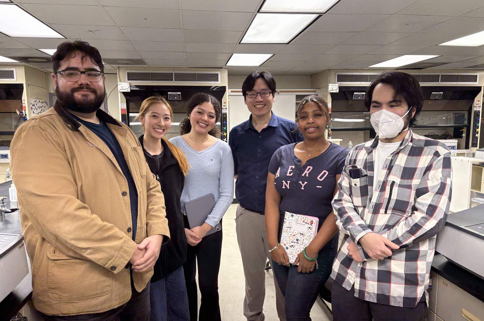Woo Lab members standing together in a CSUN laboratory