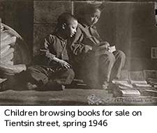 Children browsing books for sale on Tientsin street, spring 1946 
