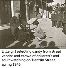 Little girl selecting candy from street vendor and crowd of children's and adult watching on Tientsin Street, spring 1946