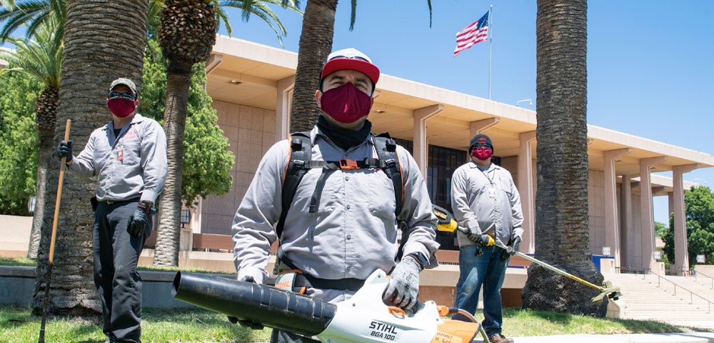 Masked Physical Plant workers on campus.