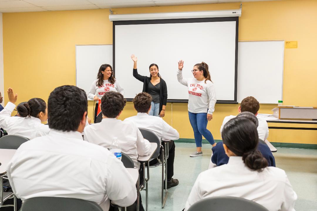 Three students making a presentation in class