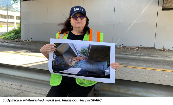 Judy Baca at whitewashed mural site. Image courtesy of SPARC