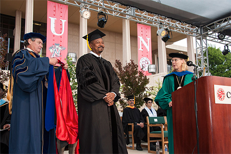 CSU Chancellor Timothy White presents Robert Townsend with his honorary CSUN doctorate as President Dianne F. Harrison looks on, during the Mike Curb College of Arts, Media and Communication commencement ceremony, May 16, 2015. Photo by David Hawkins.