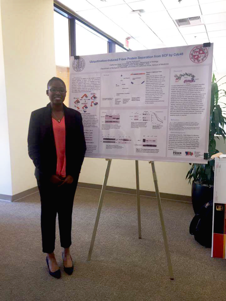 Cache smiles at camera with research poster