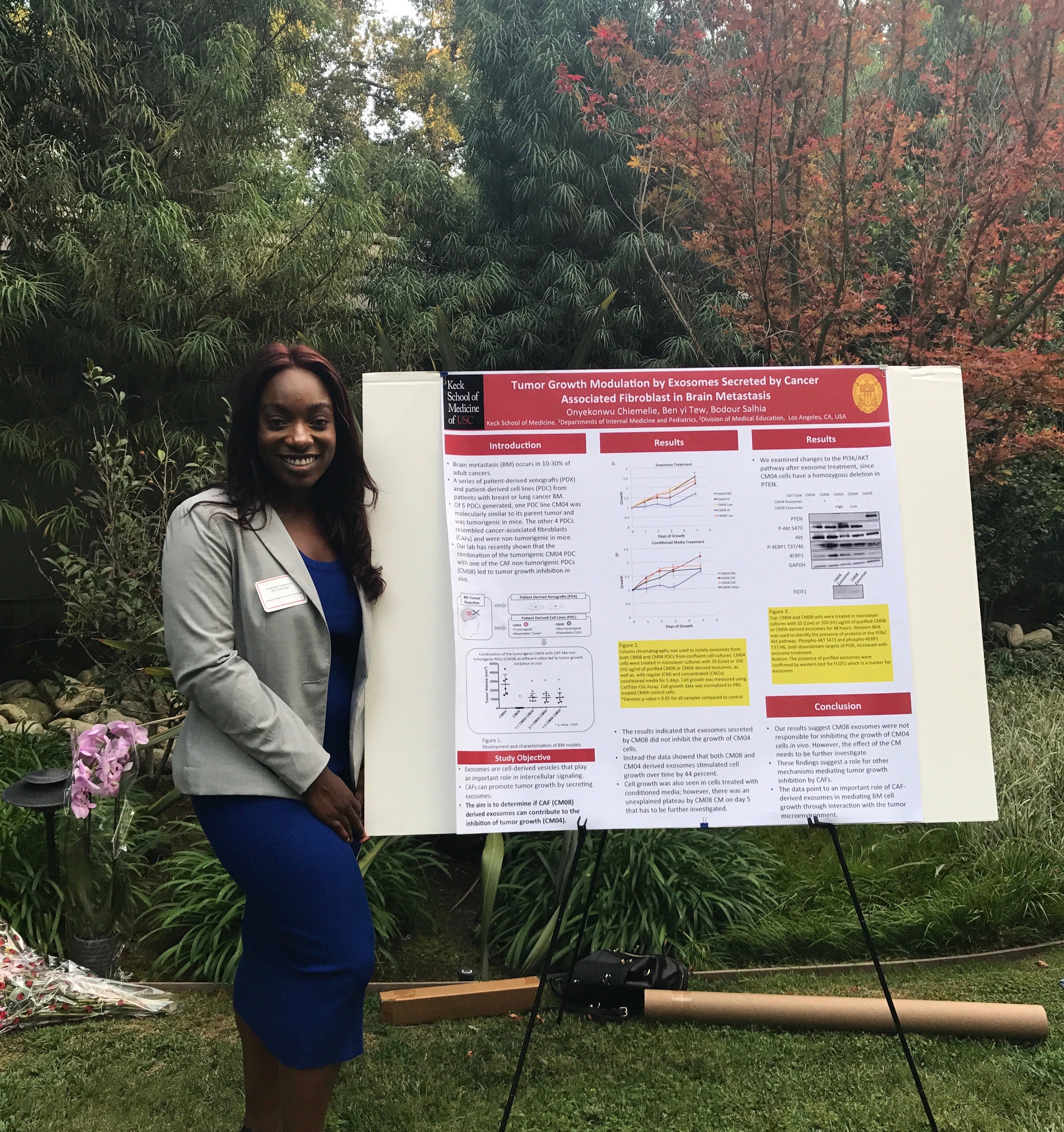 Chiemelie smiles at camera while presenting her research poster