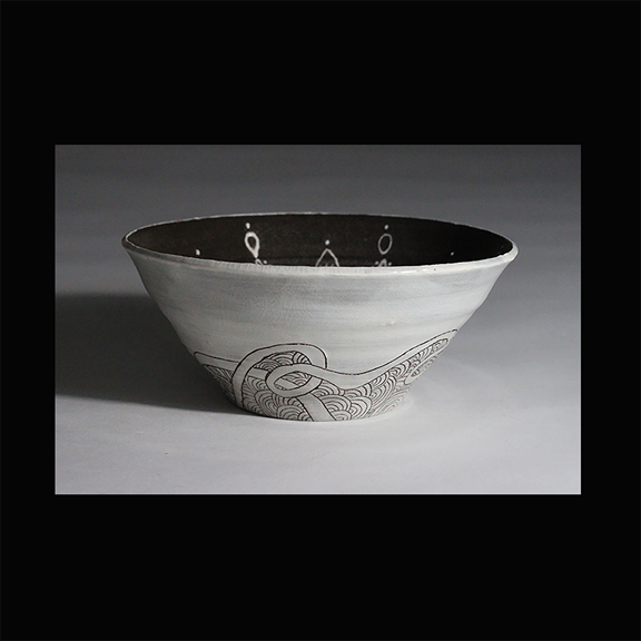 Black and white porcelain bowl with slip trailed Mandala patterns and carved ribbon designs