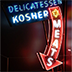 Neon sign with arrow pointing down and the words "Kosher Meats"