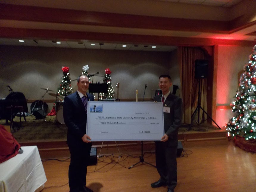 Vincent Monastersky presenting donation check to Professor Chang
