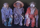 statues depicting three kneeling men