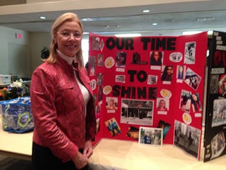 CSUN President Dianne Harrison beside CSUN Shine Poster