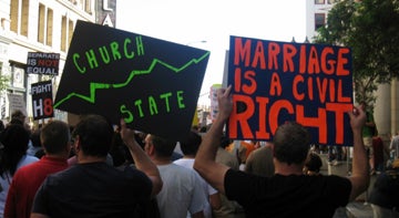 marchers holding signs that reads "Marriage is a civil right" and "church/state"