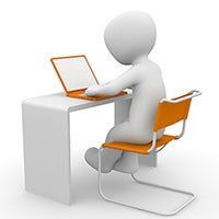 figure of person sitting in an orange chair at desk with orange laptop