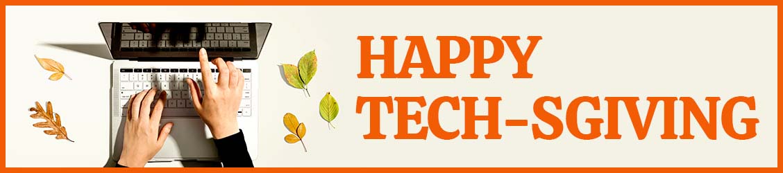 Happy Techsgiving with hands using laptop surrounded by fall leaves