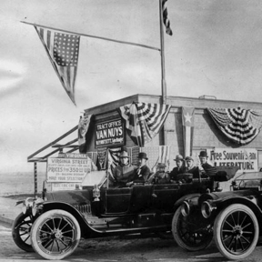 W.P. Whitsett (standing on running board of car on right) with his salesmen at his Van Nuys real estate office, 1911