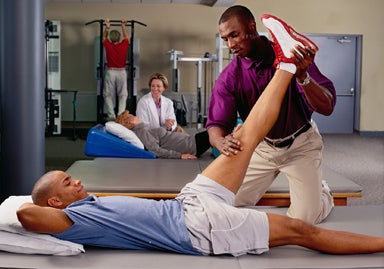 athletic trainer works with athlete on injury prevention