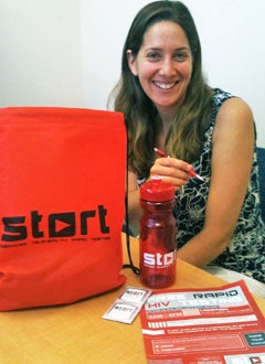 Bethany Rainisch shows contents of START student give-away bag.