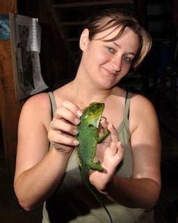 Student holding a tropical iguana