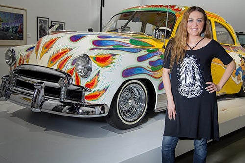 Dr. Denise Sandoval with a lowrider car
