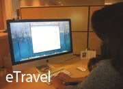 "eTravel" graphic, a woman using a computer. 