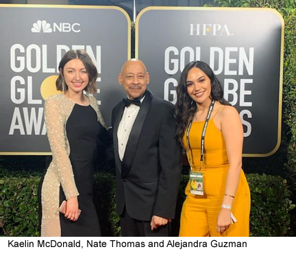 Kaelin McDonald, Nate Thomas and Alejandra Guzman standing in front of Golden Globe Awards sign