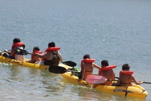 kids row a kayak on lake castaic