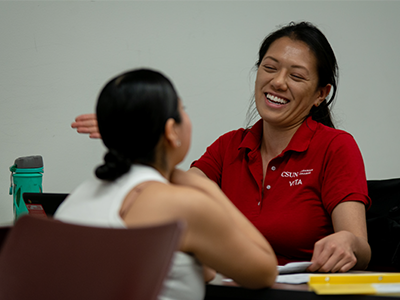 An IRS-certified student volunteer assists a taxpayer with an income tax return.