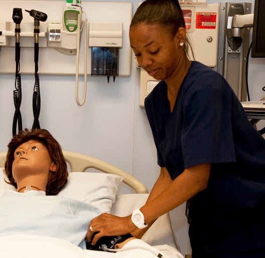nursing student practices with mannequin