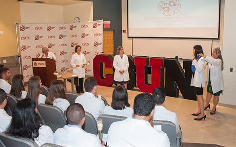 PT students and faculty participate in the 2016 white coat ceremony
