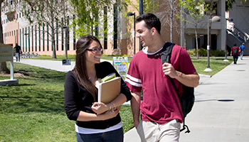 A male and female student walking on CSUN's campus.