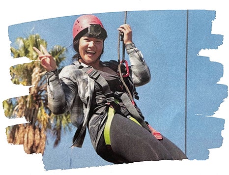 woman on ropese course smiling to camera
