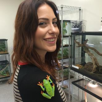 Maria Akopyan in lab with frog on her shoulder.